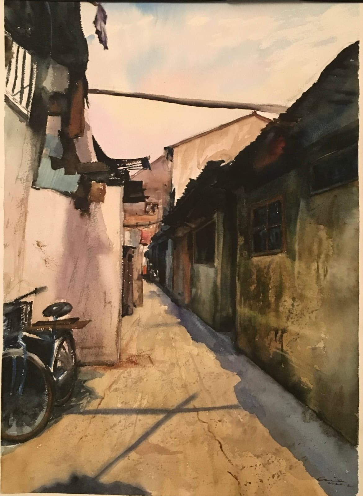 Watercolor painting of a sunlit alley with a bicycle leaning against a wall